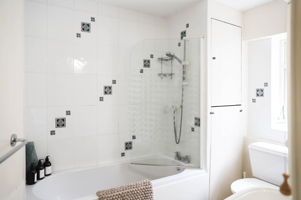 A light and airy bathroom with a shower.