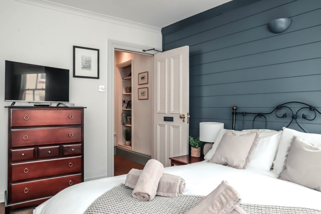 A cosy bedroom with a huge comfortable bed and TV.