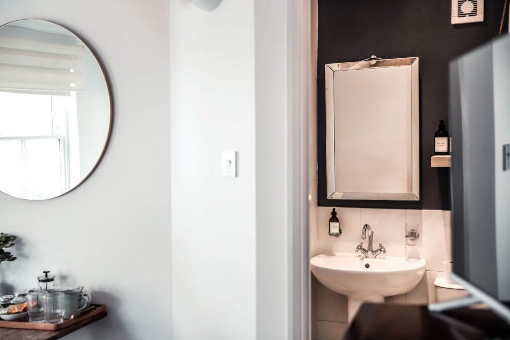 A modern bathroom with a large mirror.